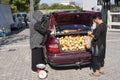 Woman sells from the trunk of her car in Athens, Greece