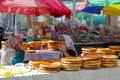 Woman sells traditional round bread at the asian market in Kyzgyzstan