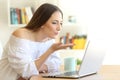 Woman sending a kiss online with a laptop