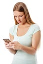 Woman sending a sms on cell phone, isolated on white. Royalty Free Stock Photo