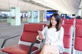 Woman sending sms on cellphone in airport Royalty Free Stock Photo