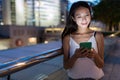 Woman sending sms on cellphone at night Royalty Free Stock Photo