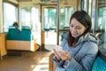 Woman sending sms on cellphone on train Royalty Free Stock Photo