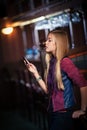 Woman sending sms on smartphone in the bar Royalty Free Stock Photo