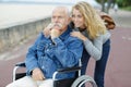 woman and senior man in wheelchair