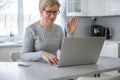 Woman senior work at a laptop close-up using modern technology in everyday life at home Royalty Free Stock Photo