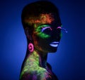 Woman sensual posing in fluorescent paint makeup