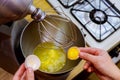 A woman separates egg white from yolk to make a sponge cake