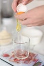 A woman separates egg yolks and whites for culinary and baking purposes