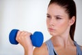 Woman, serious and exercise with dumbbells in studio, health wellness and fitness for weight loss. Young person Royalty Free Stock Photo