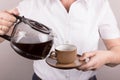 Woman serves a cup of coffee Royalty Free Stock Photo