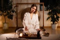 Woman serving Chinese tea in a traditional tea ceremony at home interior Royalty Free Stock Photo