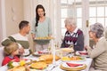 Woman serving christmas dinner to her family Royalty Free Stock Photo
