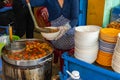 Woman serving delicious Bun Rieu- Vietnamese crab paste noodle soup