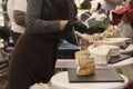 Woman Serving Fresh Cheese At Farmers Food Market Royalty Free Stock Photo