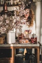 Woman serving homemade gluten free bundt cake near blooming branches