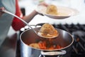 Woman serving Jewish matzon ball soup from a pot, close up