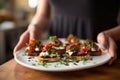 woman serving mushroom bruschetta on a plate