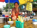 A woman is serving a noodle soup in a noodle shop at Mandalay, Myanmar