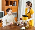 Woman serving soup at table