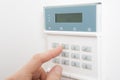 Woman Setting Control Panel On Home Security System