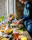 Woman setting fruits and drinks table for party Royalty Free Stock Photo