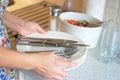 Wife seting table for for future guests Royalty Free Stock Photo