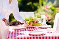 Woman setting table outdoors. Garden summer fun Royalty Free Stock Photo