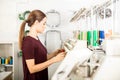 Woman setting up embroidery machine Royalty Free Stock Photo