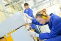 Woman setting up machine in factory Royalty Free Stock Photo