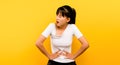 woman with severe stomach ache alone on a yellow background concept of illness and health care