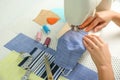 Woman sewing cloth mask with machine at table, closeup. Personal protective equipment during COVID-19 pandemic