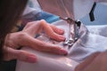 Woman sewing detail on the sewing machine. Close-up hand. Royalty Free Stock Photo