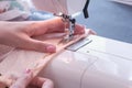 Woman sewing detail on the sewing machine. Close-up hand. Royalty Free Stock Photo