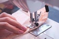 Woman sewing detail on the sewing machine. Close-up hand. Royalty Free Stock Photo