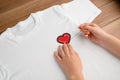 Woman sewing a heart patch