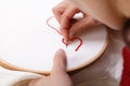 Woman sewing a Red Heart Shaped Decoration Royalty Free Stock Photo