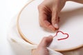 Woman sewing a Red Heart Shaped Decoration Royalty Free Stock Photo