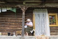 A woman sews on the patio