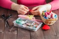 Woman sews red heart shaped toy by needle Royalty Free Stock Photo