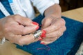 A woman sews with red thread Royalty Free Stock Photo