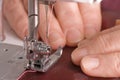 Woman sews on the sewing machine