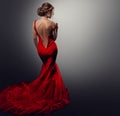 Woman sexy Back undressing Red Dress. Model in Evening Gown Rear Side view. Sensual Women Body Shape Silhouette over Gray