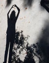 Woman shadow in concrete with fallen leaves