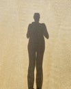 Woman shadow at sand. Walking on the beach. Self portrait Royalty Free Stock Photo
