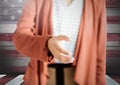 Woman shaking hand against american wooden flag