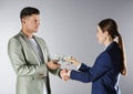 Woman shaking hands with man and offering bribe on background Royalty Free Stock Photo