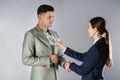 Woman shaking hands with man and offering bribe on grey background Royalty Free Stock Photo