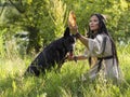 Woman shaman talking to a dog