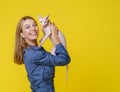 Woman shares heartwarming moment with beloved cat and kisses it affectionately and holds it in hands. Deep bond and love
